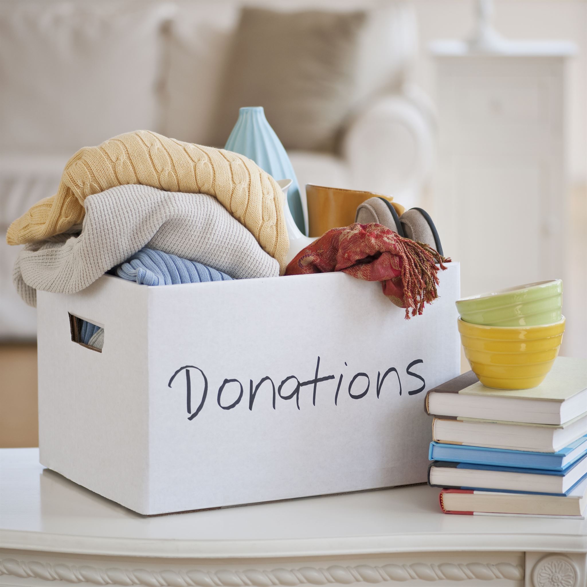 Donation-box-with-clothes-on-table-2